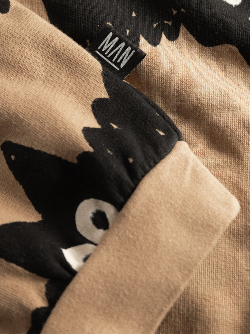 brown organic sweater detail label